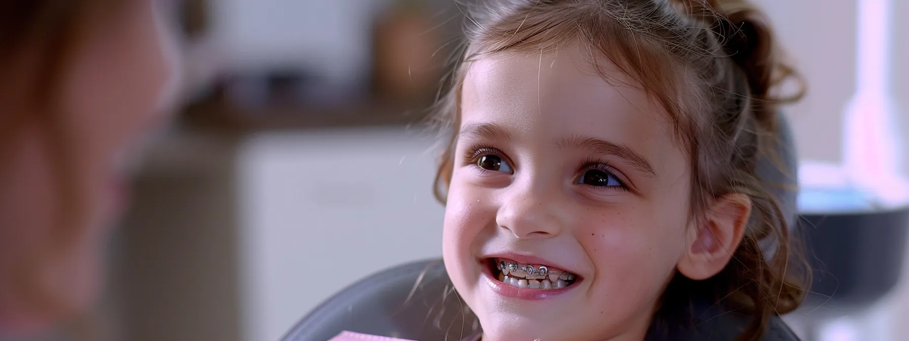 a young child at the orthodontist's office receiving an evaluation for misalignment issues.