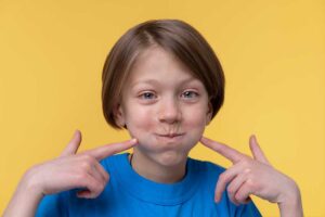 young girl pointing to jaw